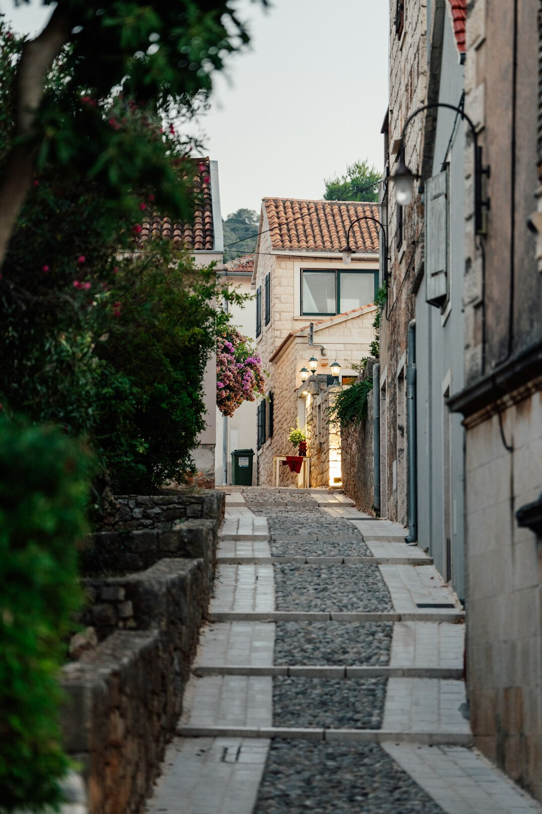 Narrow cobblestone street in an old European coastal town at dusk